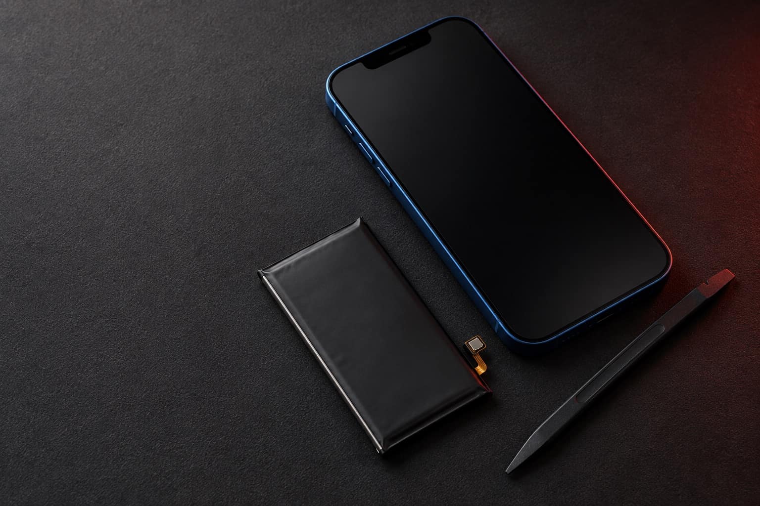 Blue iPhone 12 on a repair mat next to a replacement battery and a spudger