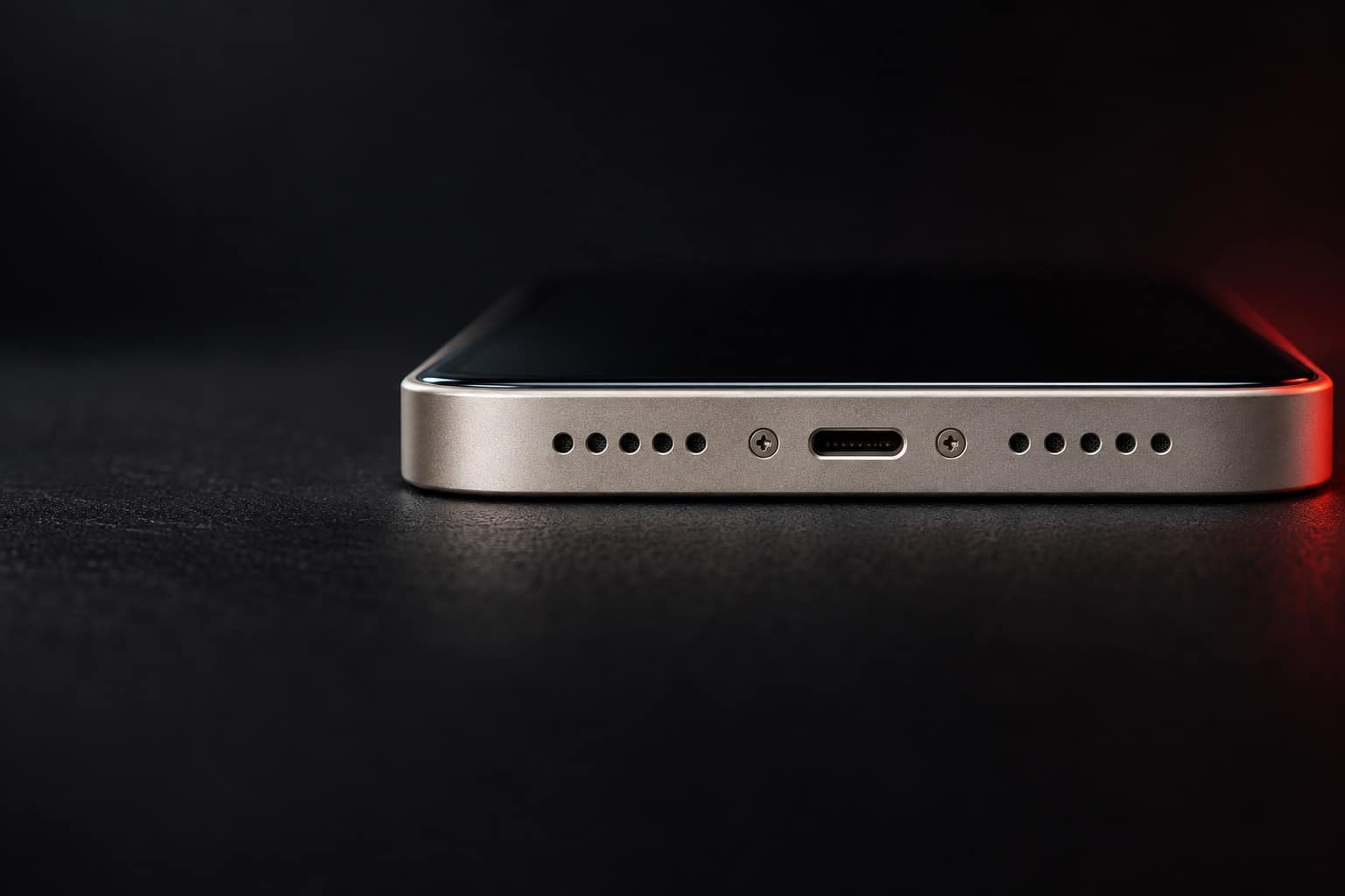 Bottom edge of a starlight iPhone 13 showing the Lightning charging port and speaker grilles