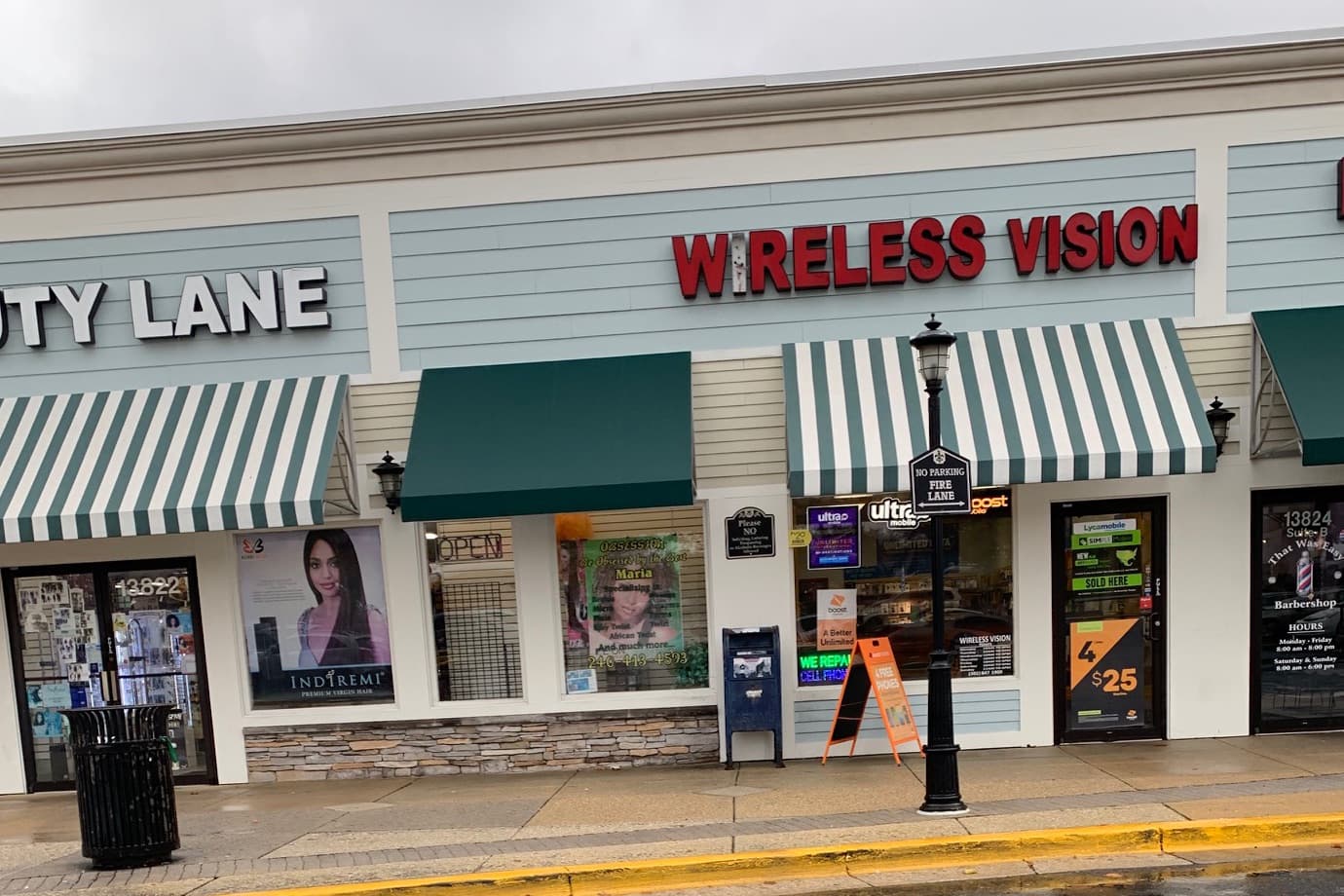 Wireless Vision storefront with a red sign and striped awning in Briggs Chaney Market Place, Silver Spring